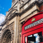 Ornate facade of the Victoria and Albert Museum in London with a red telephone box in the foreground